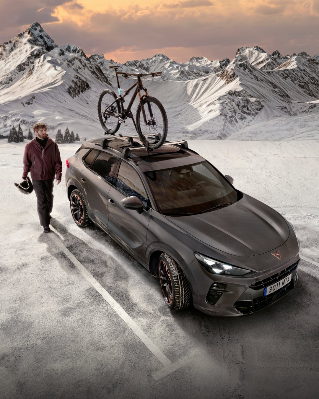 woman using my cupra app on phone during the night for remote monitoring of plug-in hybrid electric vehicle