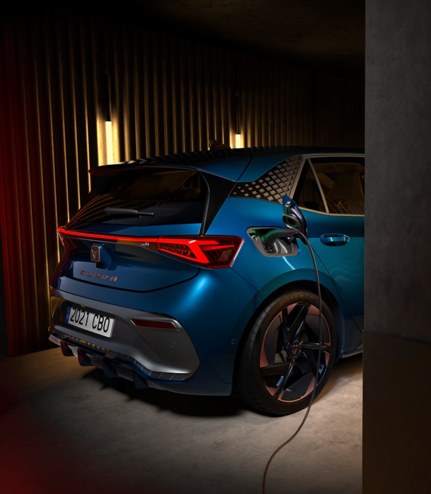 CUPRA%20bord%20aurora%20Blue%20cColour%20plugged%20into%20a%20Cupra%20 Charcherger