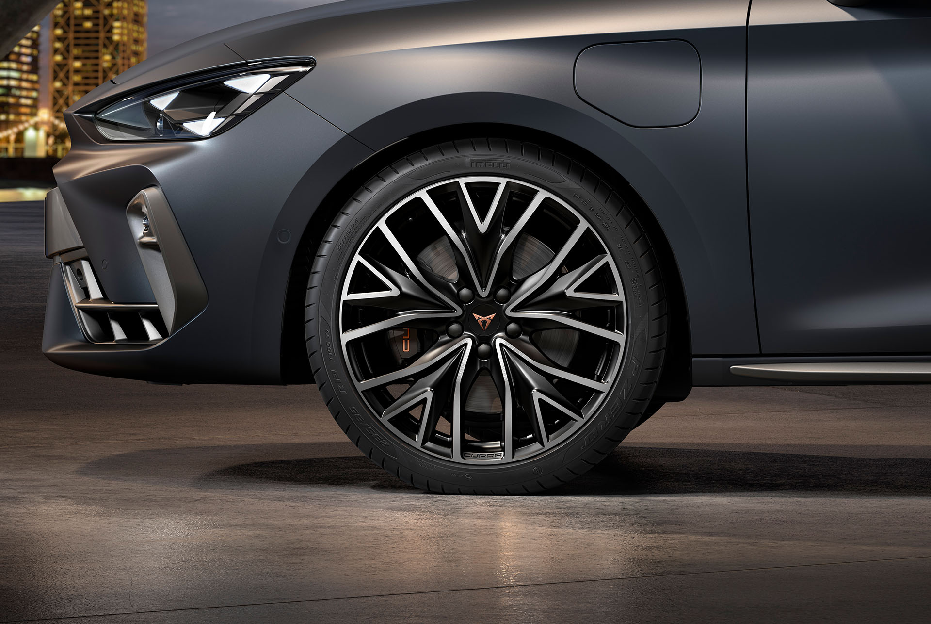 Vue latérale avant gauche des jantes en alliage usinées en Argent et Noir, pneus, phares signature et carrosserie grise de la nouvelle Cupra Leon 2024