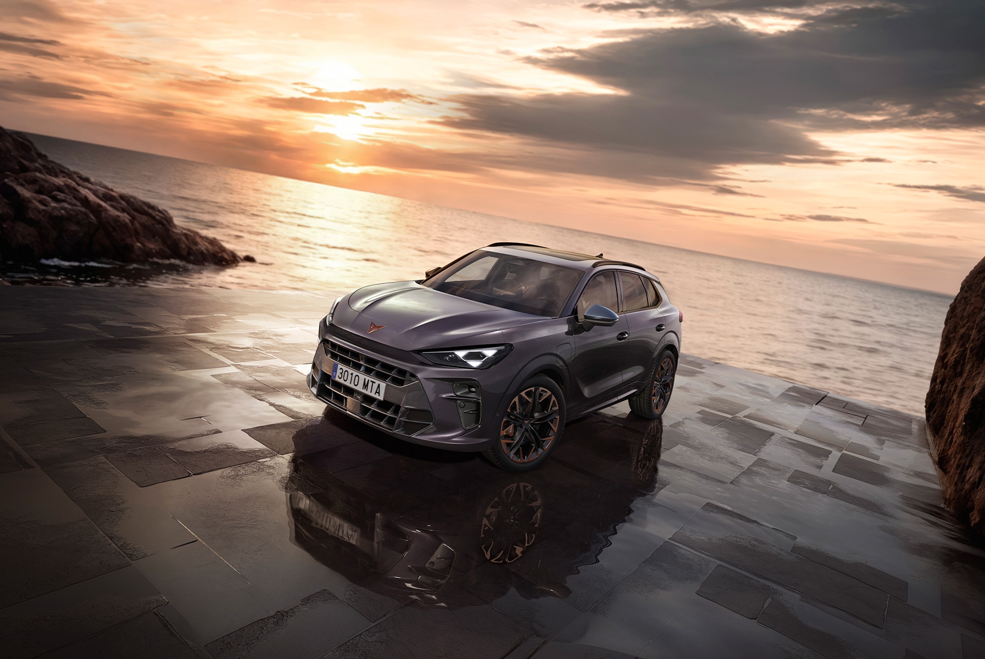 CUPRA terramar hybrid suv, 2025 model, front view, featuring sleek headlights, modern alloy wheels, and a shark-inspired front design, on a wet pavement by the sea at sunset.