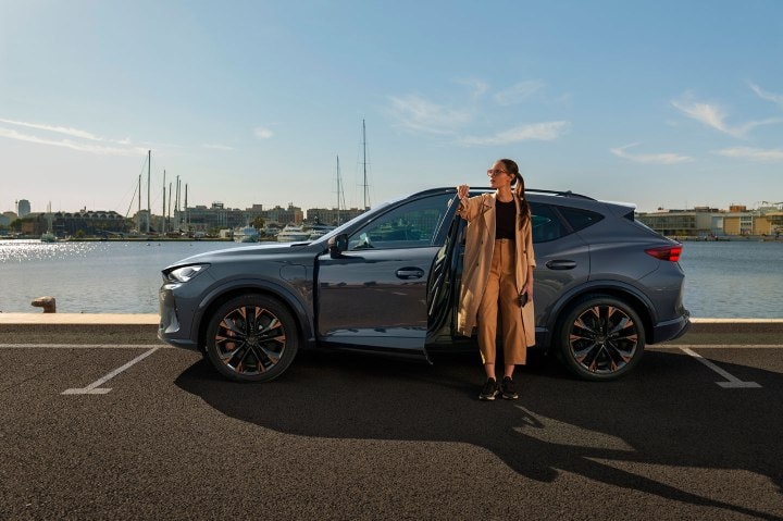 Woman exiting the cupra  tavascan obtained through classical credit leasing with no balloon payment. Woman exiting the cupra  tavascan obtained through classical credit leasing with no balloon payment.